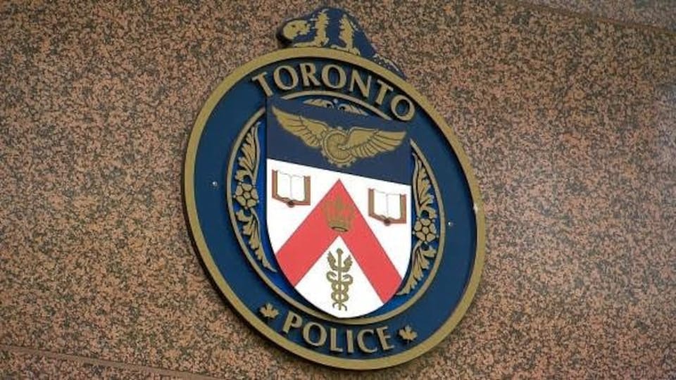 The Toronto Police logo on a wall.