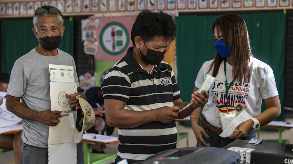 Voters exercise their right to vote at the polling station.