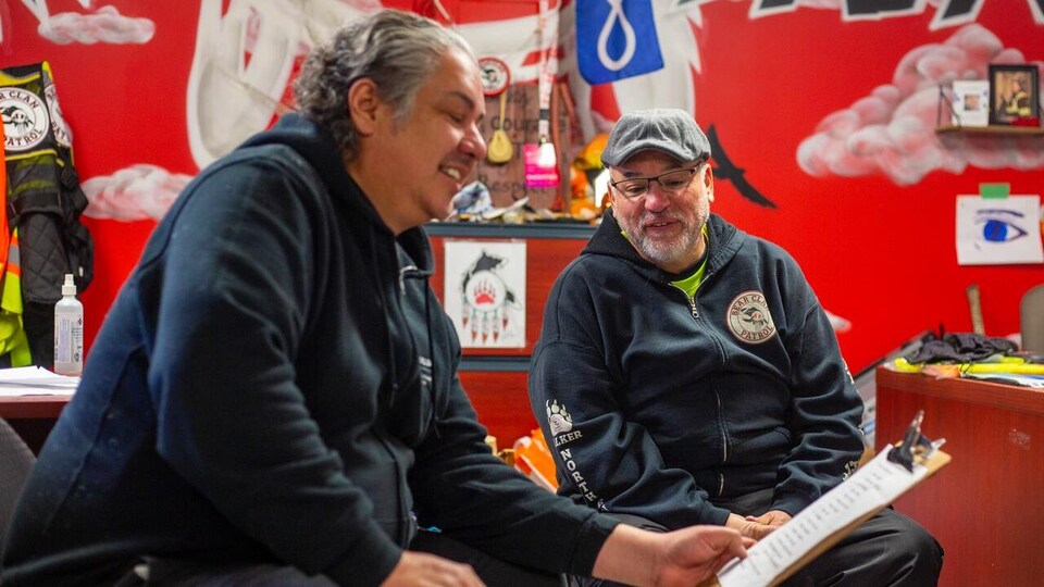 Deux hommes lisant un document.