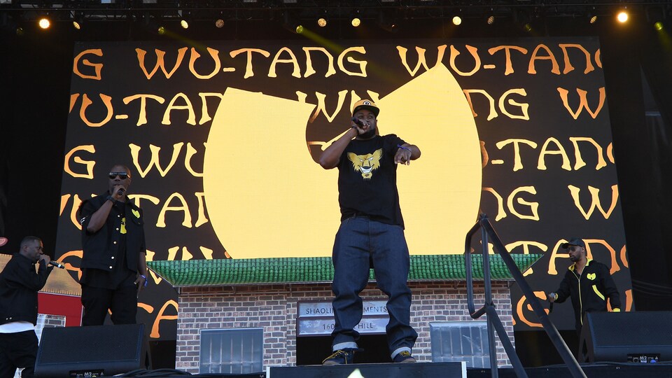 Des chanteurs de rap tiennent des micros dans leurs mains lors d'un spectacle à New York.