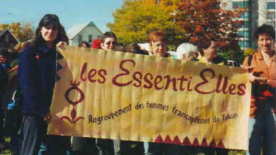 Des femmes tiennent une banderole sur une photo d'archives.