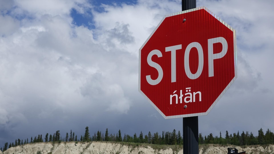 Un panneau d'arrêt traduit dans une langue autochtone.