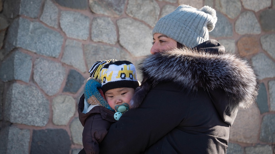 Michelle Frissen and her son Theo outside Whitehorse City Hall on March 8, 2023.