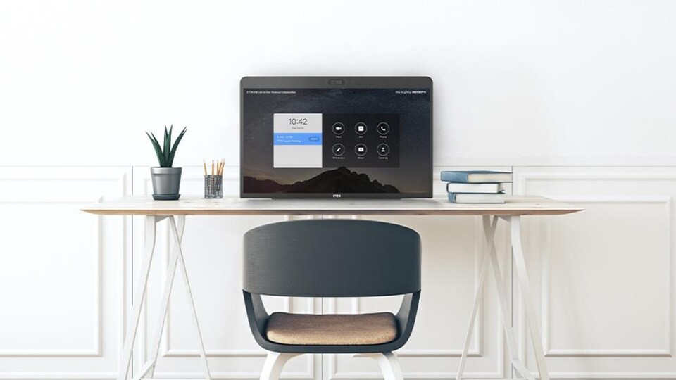 Un grand écran sur un bureau de travail minimaliste.