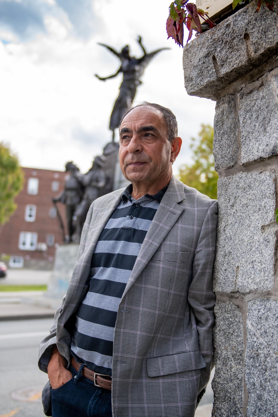 M. Habibi adossé sur un mur de briques au centre-ville de Sherbrooke. 