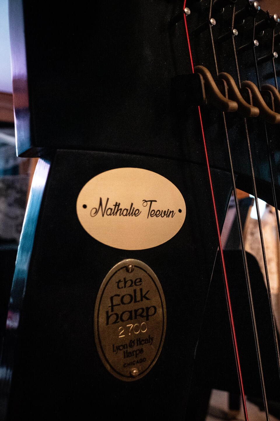 Sur le cadre d'une harpe celtique, une petite plaque dorée porte le nom de Nathalie Teevin, une harpiste de Québec.
