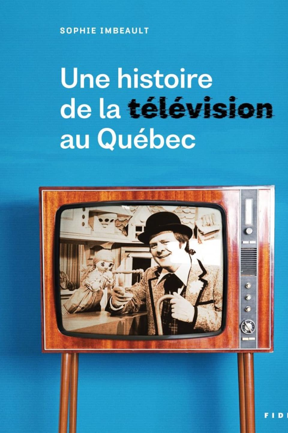 Page couverture du livre. Un vieux téléviseur montre un homme avec un chapeau melon (Bobino) parlant à une marionnette.