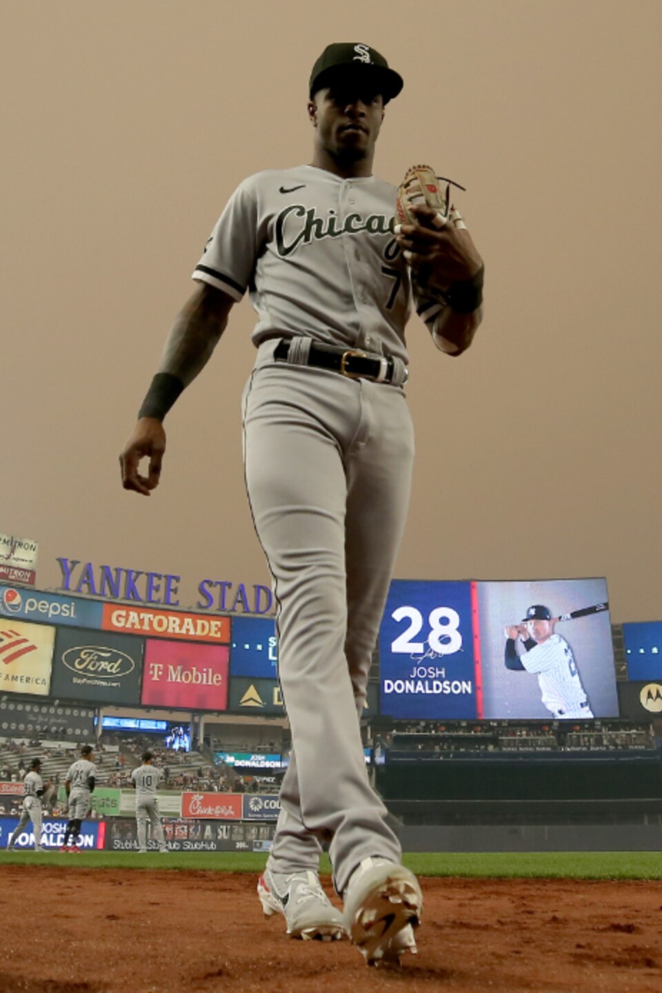Un joueur de baseball sur fond de ciel gris opaque.