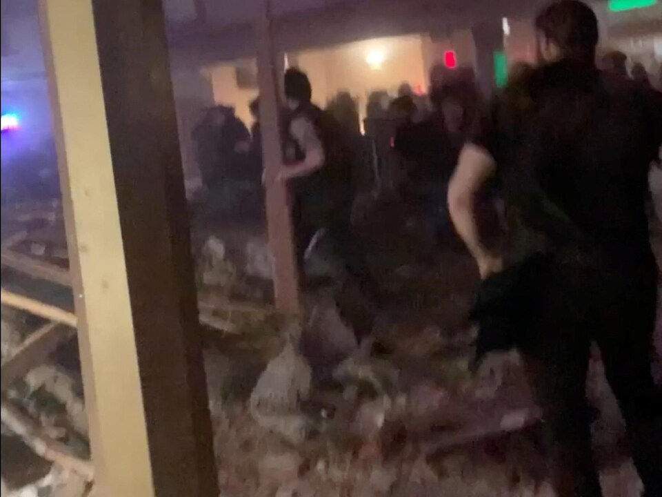 People amid debris inside the Apollo Theater.