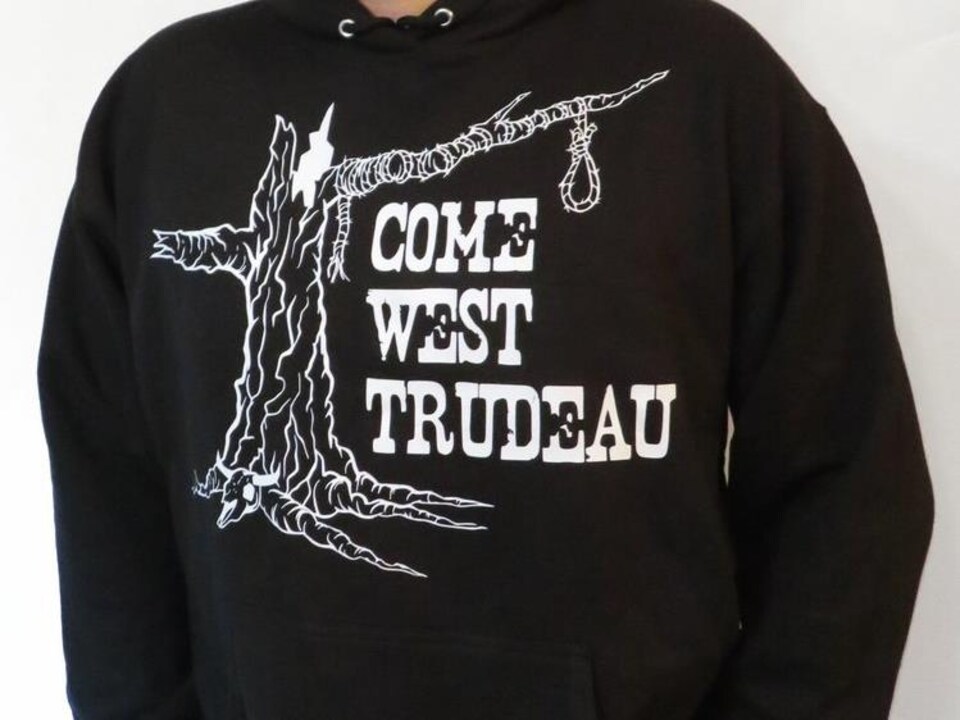Un chandail sur lequel on peut voir un arbre avec un noeud coulant, ainsi que le message « Come West Trudeau ».