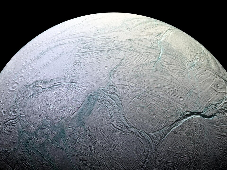 The frozen surface of Enceladus, a moon of Saturn, as seen by the Cassini spacecraft. 