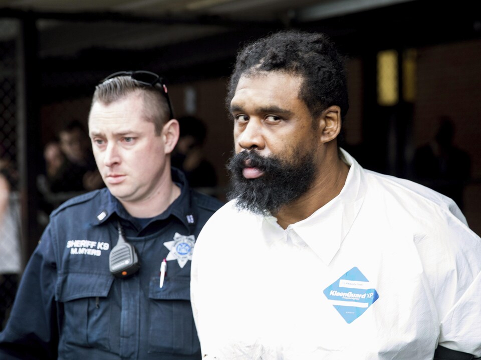 Ramapo police officers escort Grafton Thomas from Ramapo City Hall to a police vehicle on Sunday, December 29, 2019, in Ramapo, New York. 