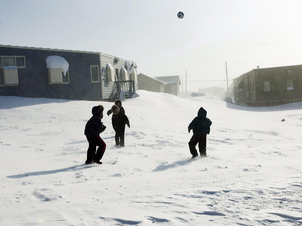 Des enfants jouent au soccer dans la neige dans la petite ville de Baker Lake, au Nunavut.