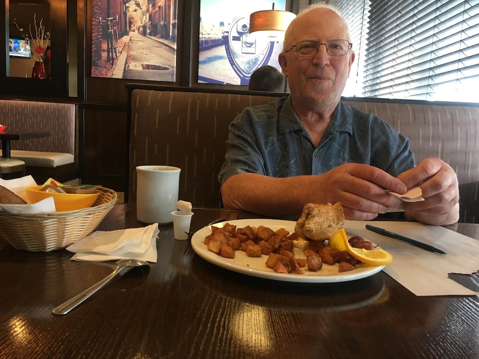 Jon Kramer en train de prendre son petit-déjeuner dans un restaurant.