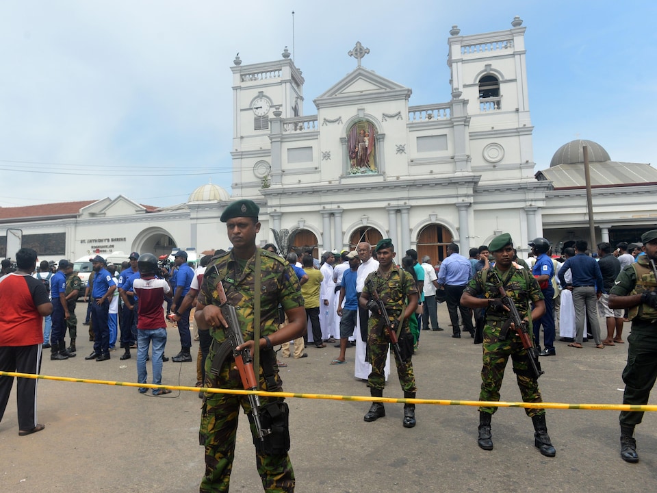 Armed police guard a church that was the scene of the explosion.