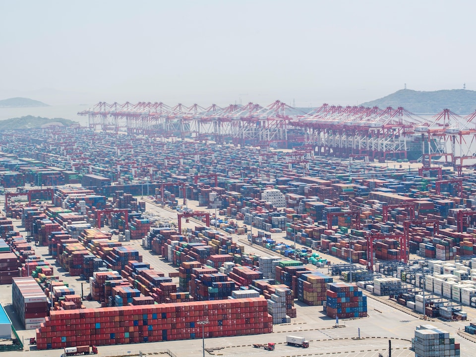 Thousands of containers were stacked in rows.  Large cranes lined the horizon.  In the distance, sea and mountains.