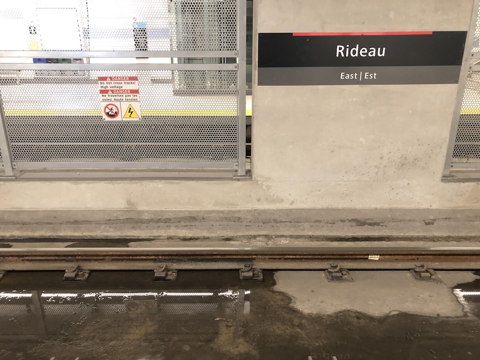 De l'eau stagnante est visible sur les rails du train léger à la station Rideau.