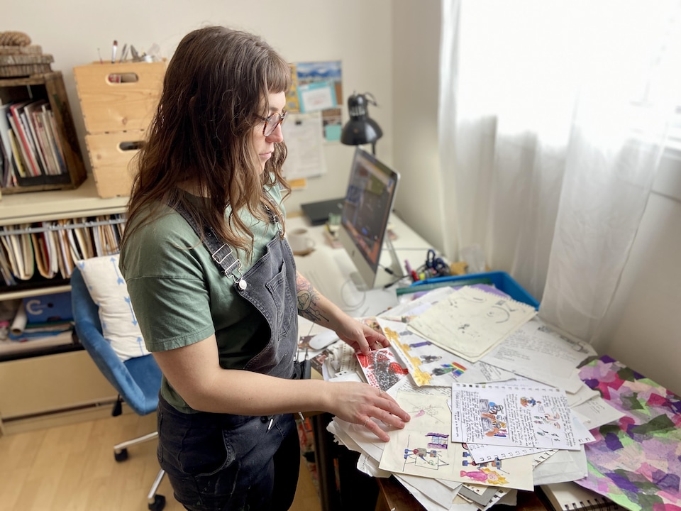 Alexandra Tanguay-Viriault studies illustrations at a desk.