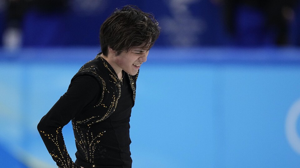 An ice skater frowns on the ice.