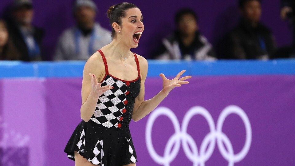 A skater smiles with her mouth wide open after her performance