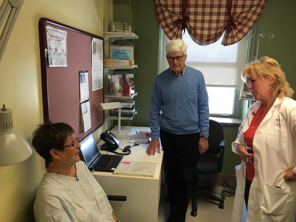 Une patiente est assise dans une salle d'examen avec l'infirmière Ginette Chouinard.
