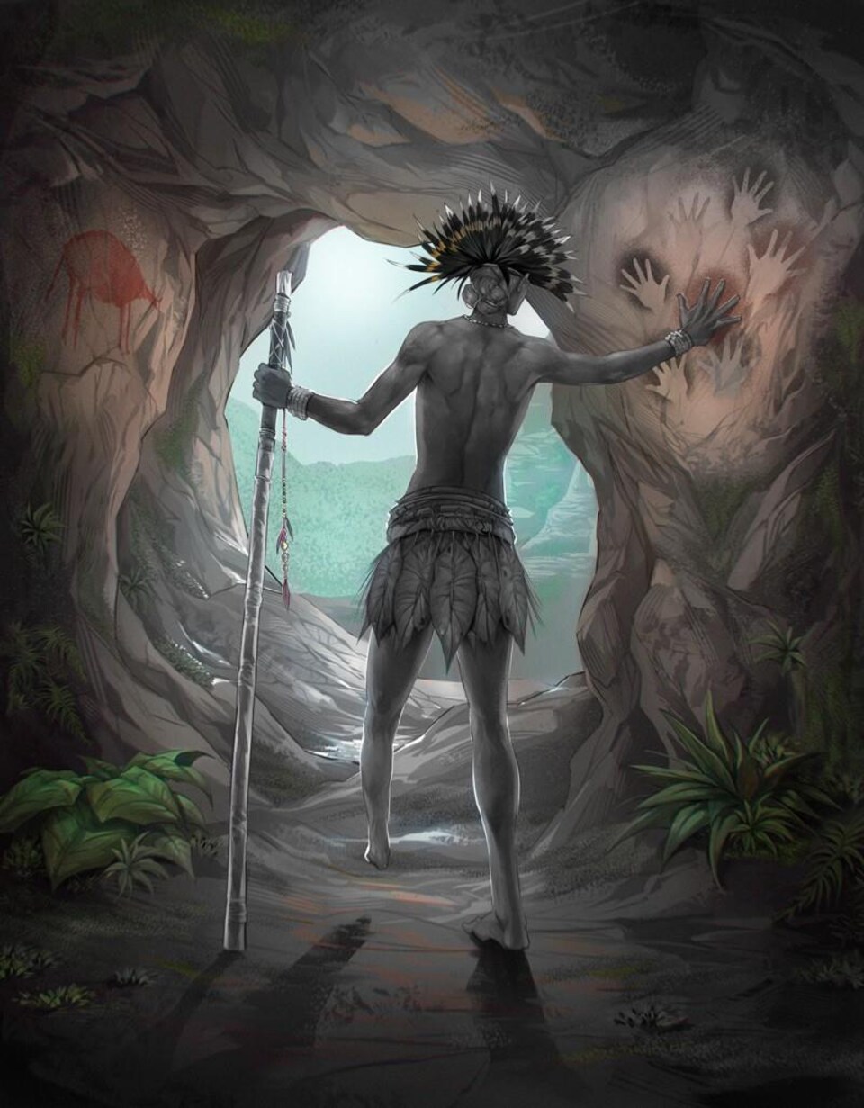 A man stands in a cave with the lower part of his left leg amputated.