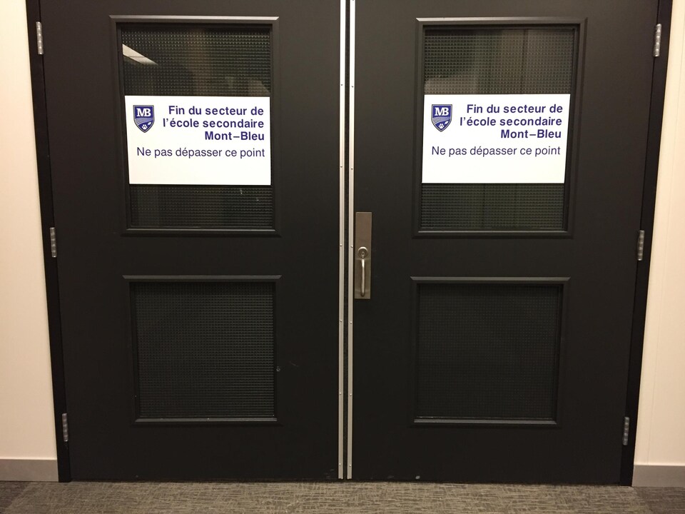 Des portes noires sur lesquelles on peut lire : fin du secteur de l'école secondaire Mont-Bleu. 