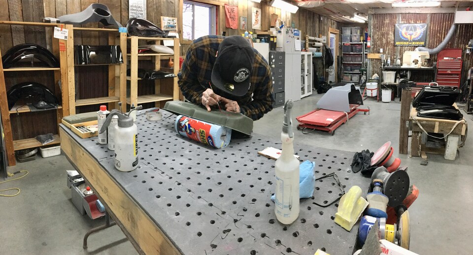 Dominic Simard peint une pièce dans son atelier.