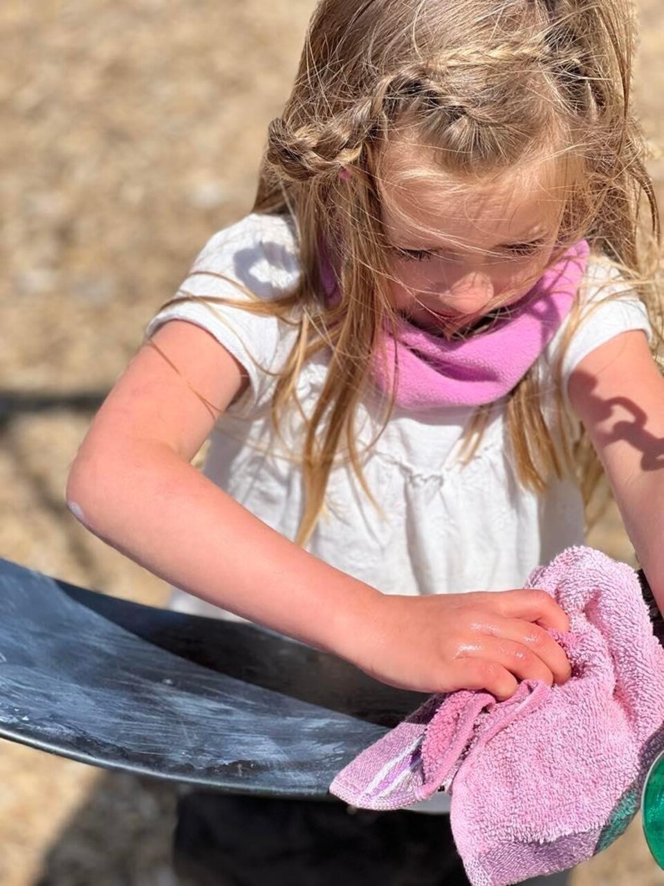 A girl is cleaning the swing.