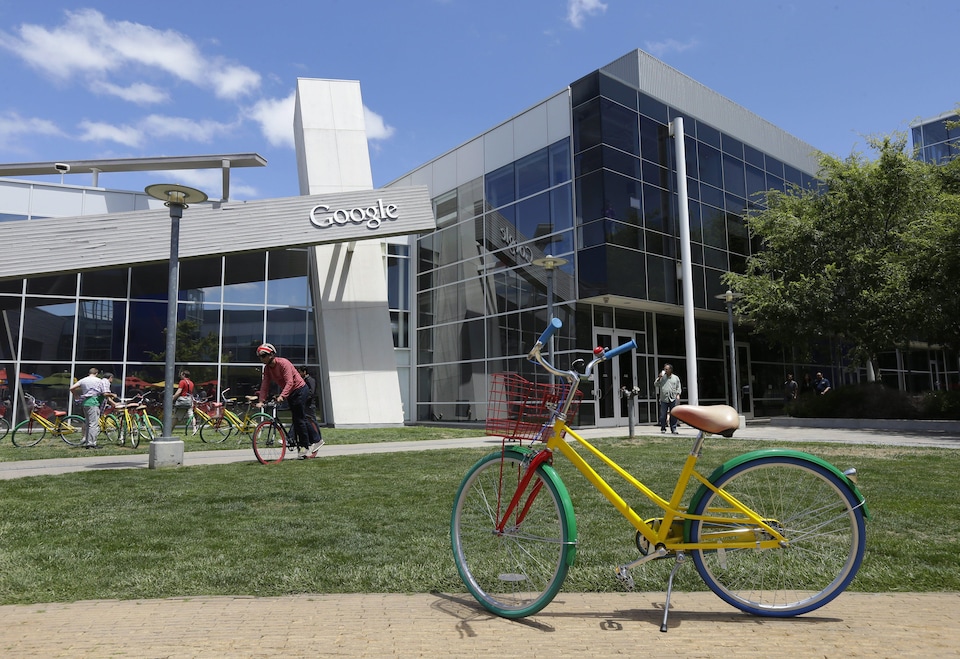 Employees travel around campus via bicycles at Google headquarters Tuesday, July 16, 2013, in Mountain View, Calif. Google reports quarterly earns on Thursday, July 18, 2013. (AP Photo/Ben Margot)