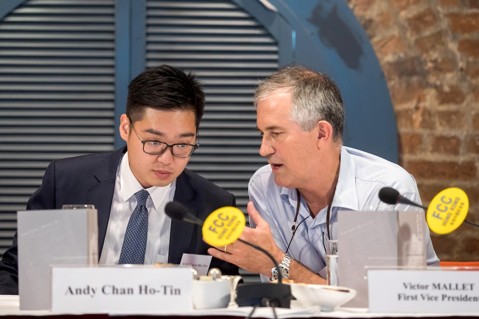 Victor Mallet, Financial Times journalist and first vice president of the Foreign Correspondents' Club (FCC), speaks with Andy Chan, founder of the Hong Kong National Party, during a luncheon at the FCC in Hong Kong, China, August 14, 2018. Picture taken August 14, 2018.   Paul Yeung/Pool via REUTERS
