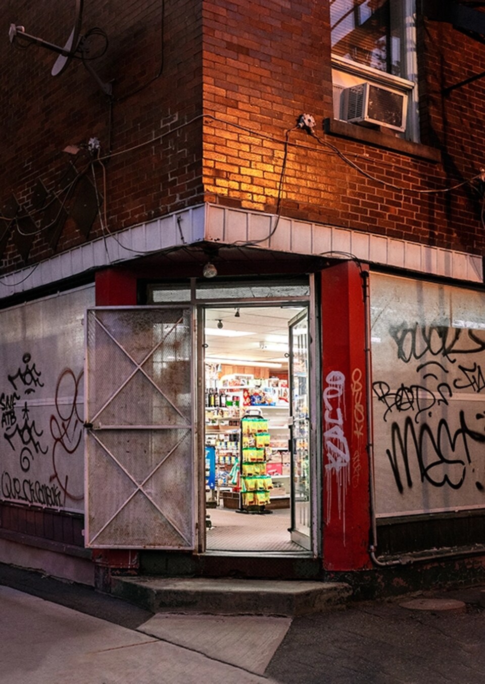 Un dépanneur avec une porte ouverte au coin d'une rue.