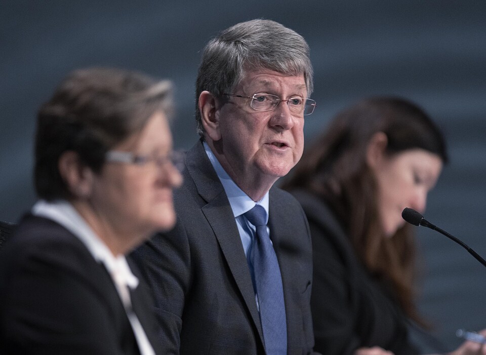 Michael MacDonald was speaking, sitting between his two colleagues.
