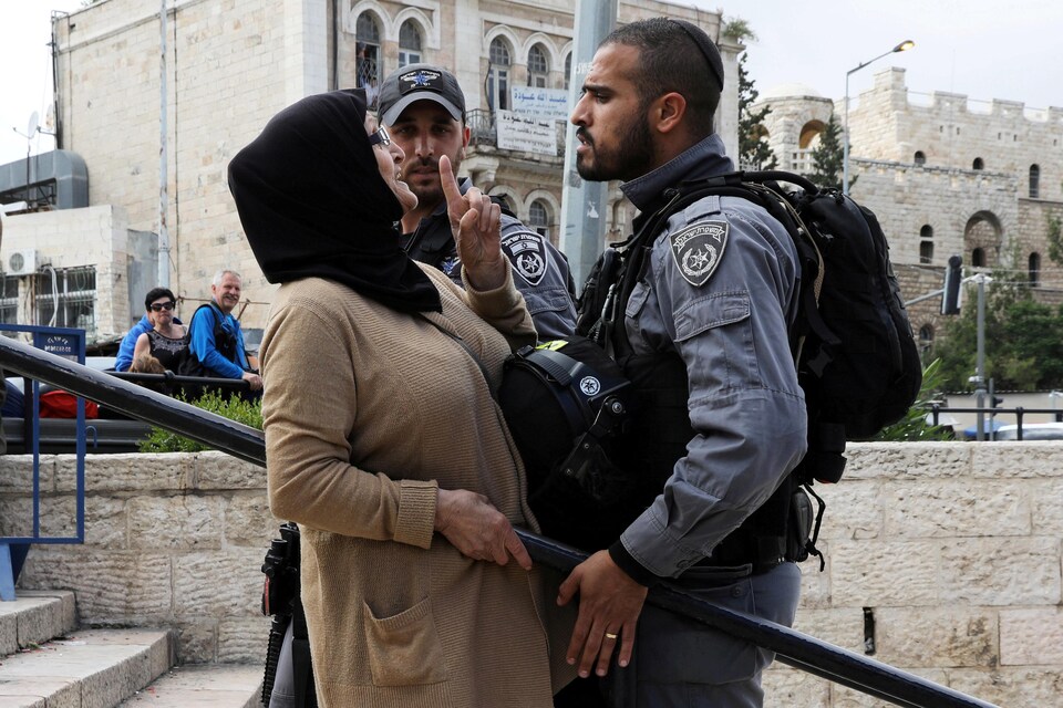 Un policier israélien argumente avec une Palestinienne à Jérusalem, le 13 mai 2018.