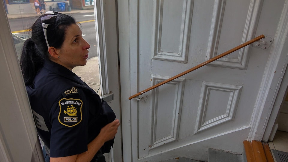 La sergente Julie Marcotte dans l'entrée d'une maison spécialisée pour les personnes atteintes de troubles mentaux.