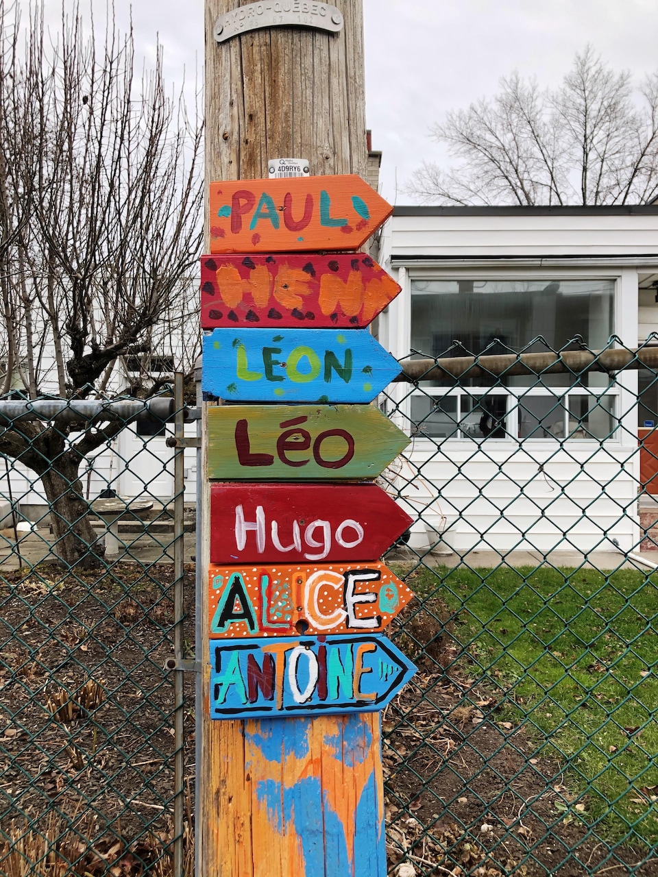 The children's names were written on wooden boards attached to a telephone pole.