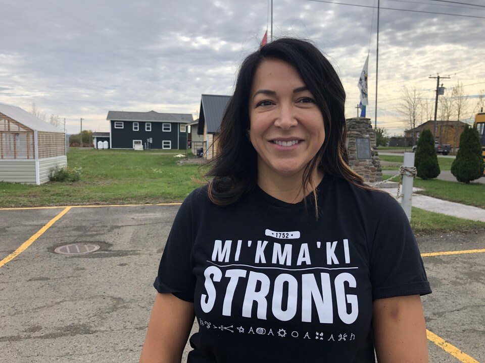 Une femme debout à l'extérieur porte un t-shirt « Mi'kma'ki Strong ».