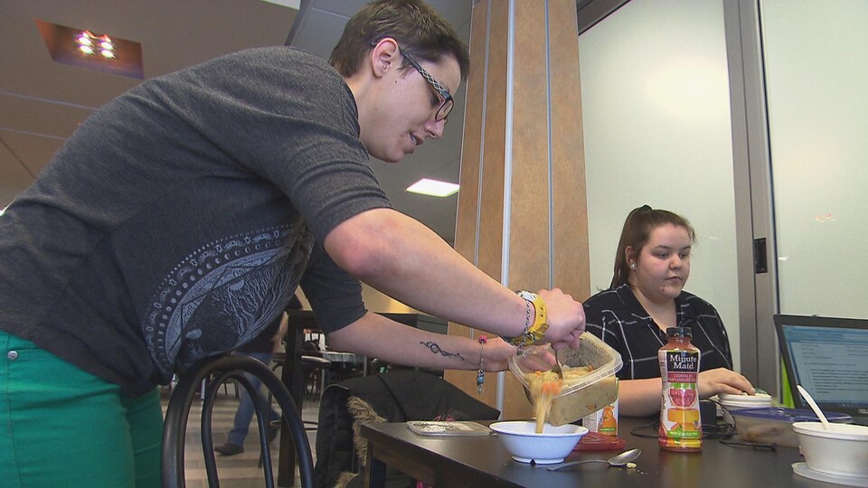 Stéphanie St-Jean Savard se prépare à savourer une soupe aux pois et légumes qu'elle vient de récupérer au frigo communautaire.