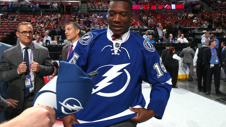 A player receives a cap in an arena.