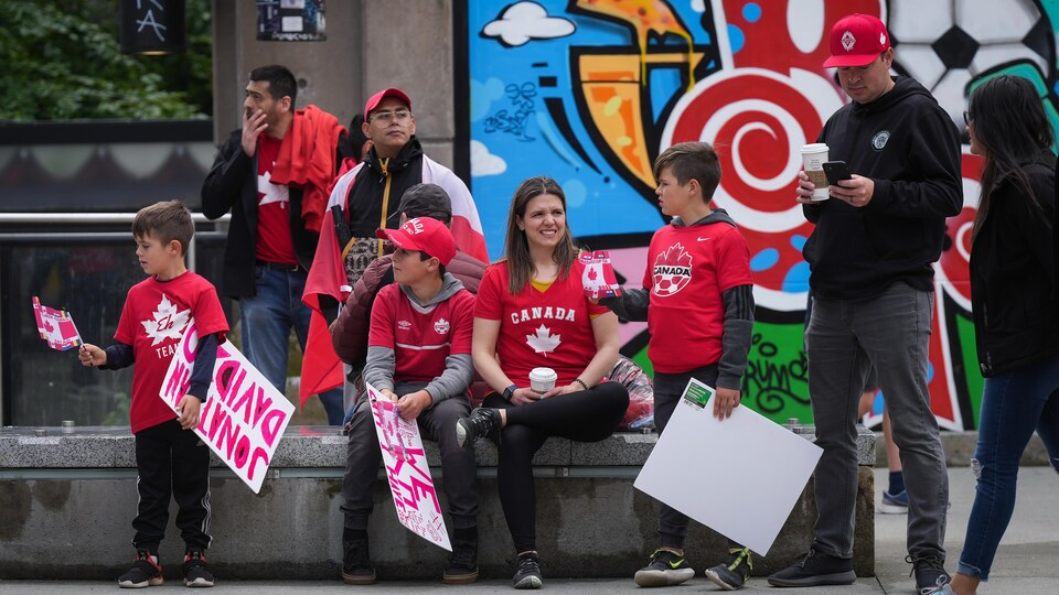 Supporters of the Canadian soccer team wait outside the stadium.