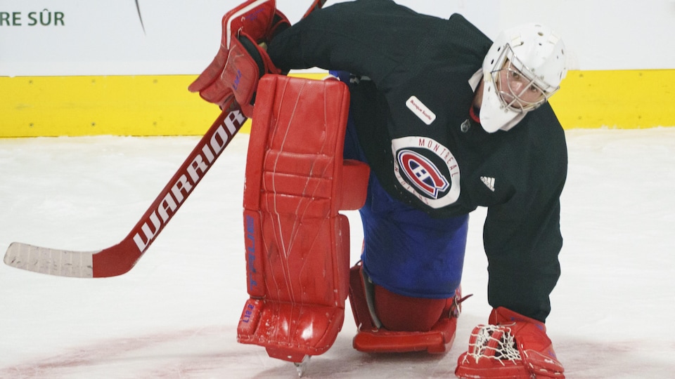 With one knee on the ice, he warms up before exercising.