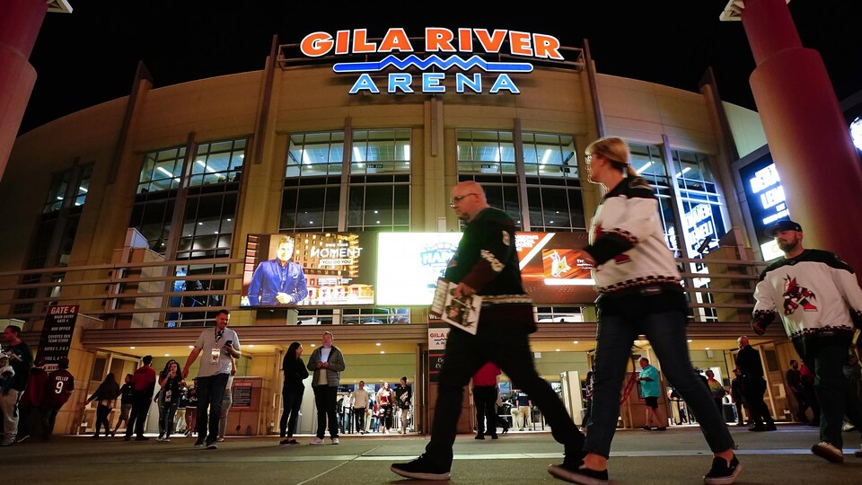 People walk into the Arizona Coyotes ’Gila River Arena at the end of a game. 