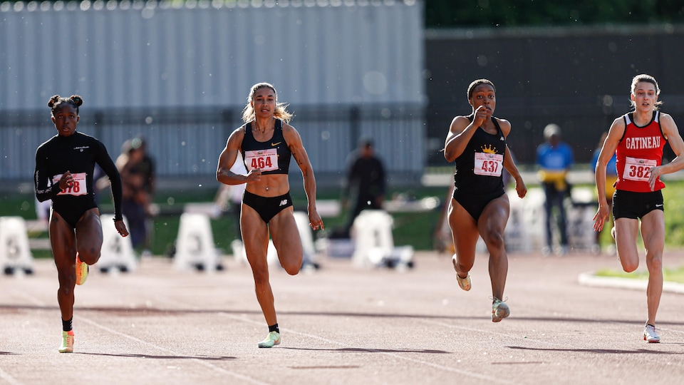 Athletes run on an athletics track.