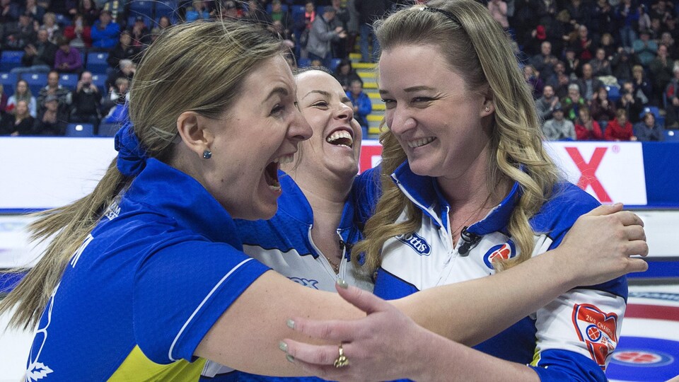 Trois femmes célébrant un championnat de curling.