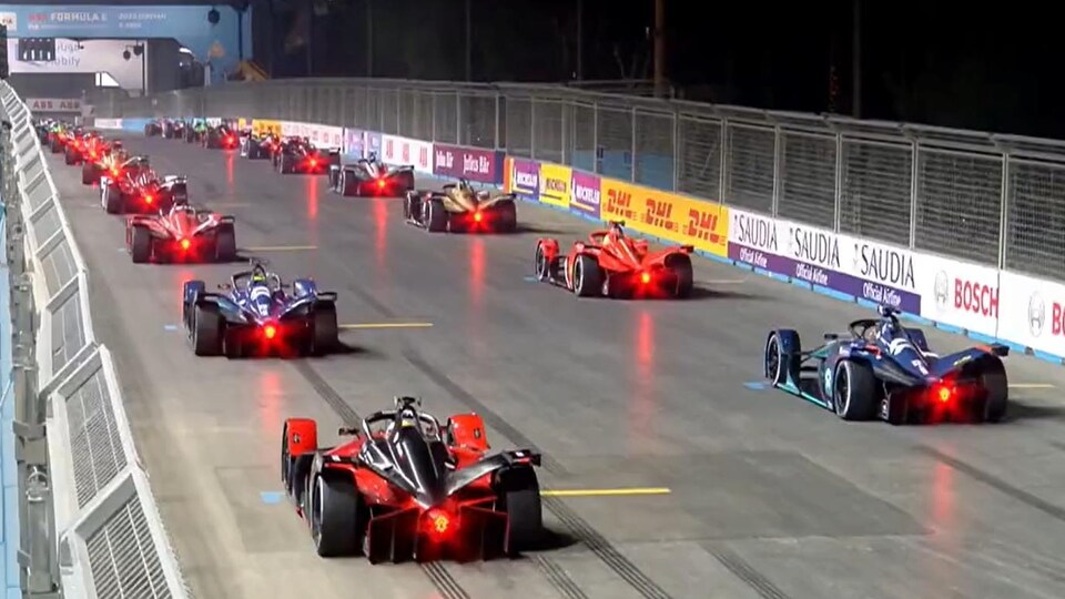 Vehicles in the rear on the starting grid of a night competition