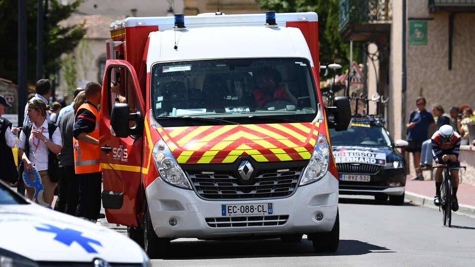 Une ambulance s'arrête pour conduire à l'hôpital un coureur blessé.