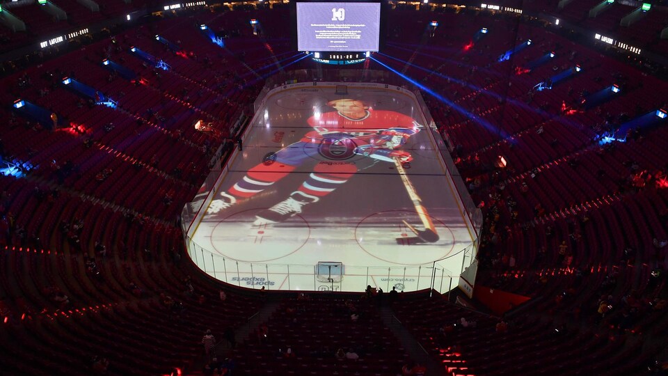 An image of Guy Lafleur is projected onto the ice rink at the Bell Centre.