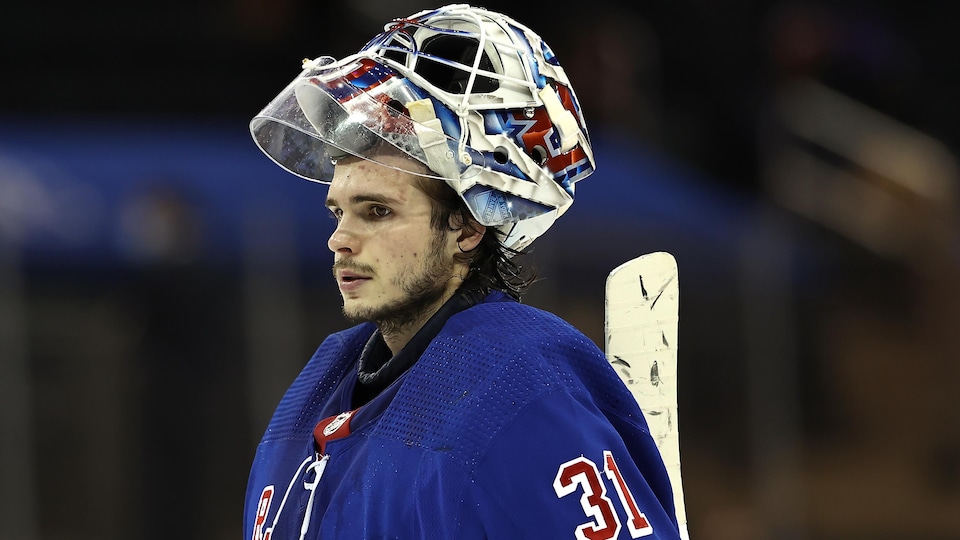 A guard turned blue, his mask raised over his head.