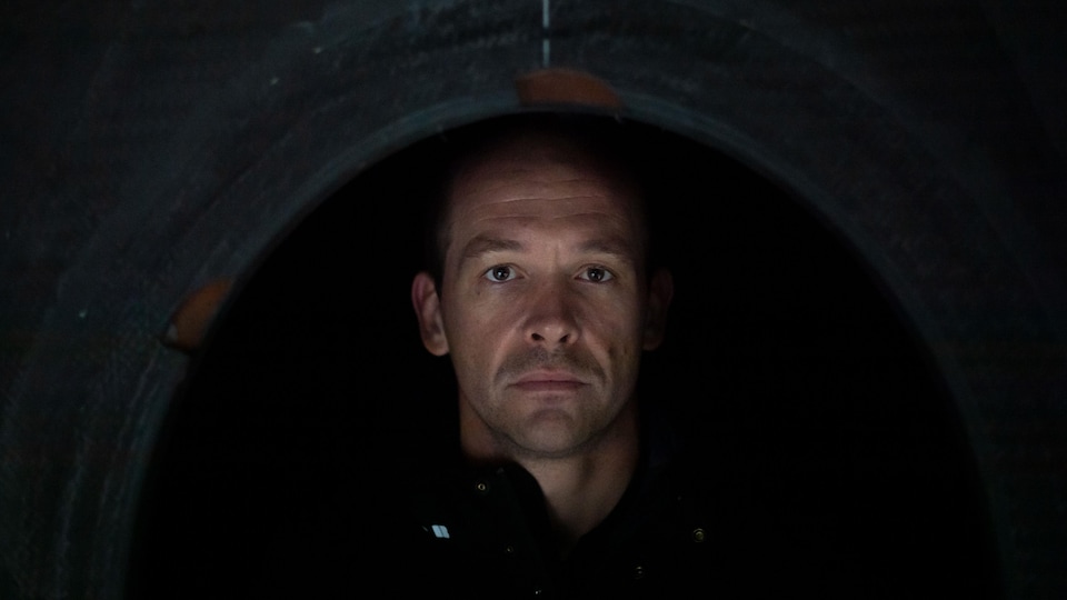 Un homme en noir dans son bateau