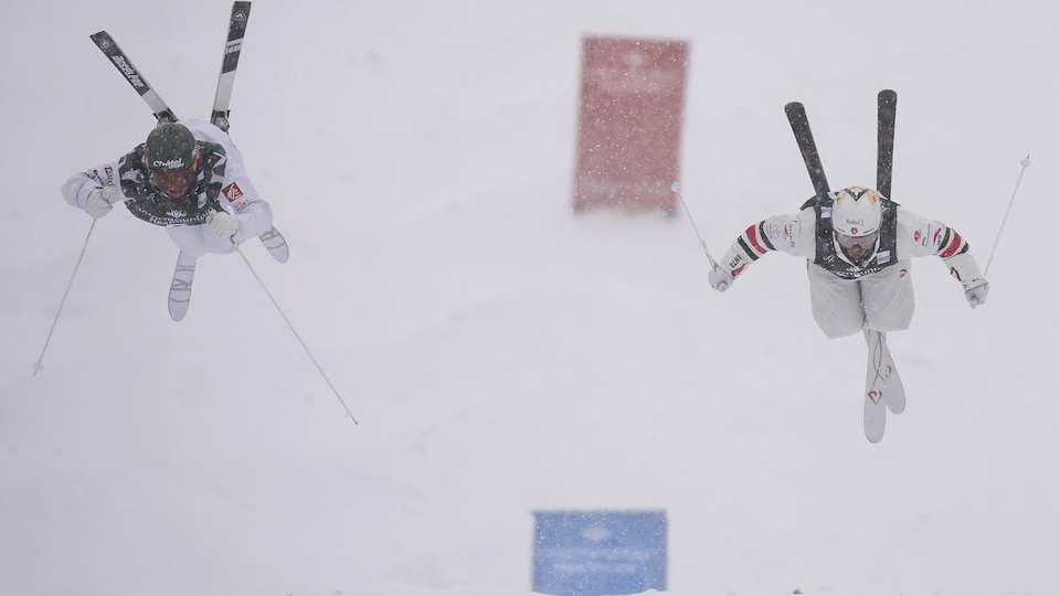 Mikaël Kingsbury et Benjamin Cavet effectuent un saut.